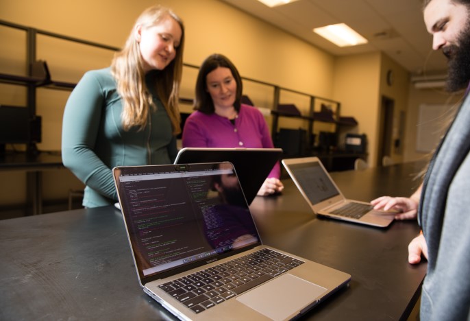 Faculty and students working on their laptops